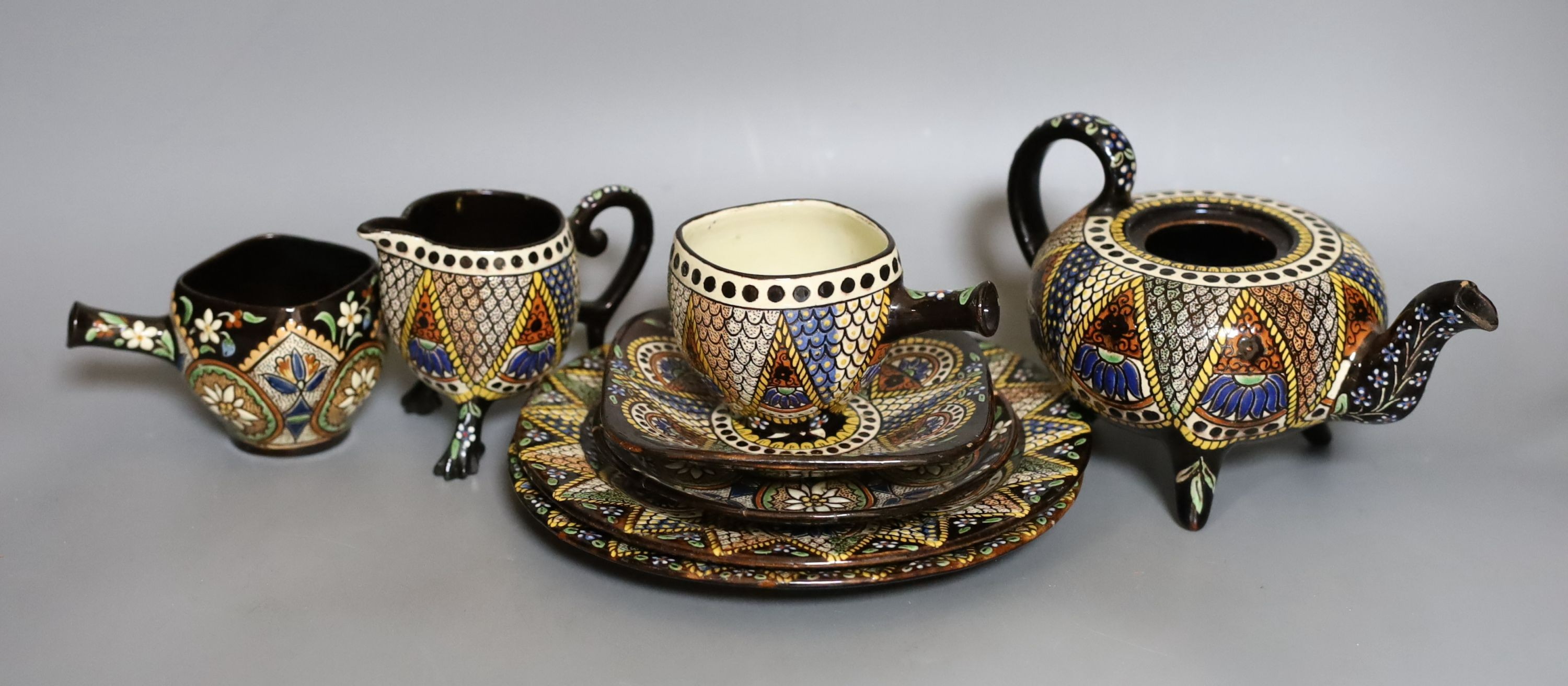 A Swiss Thoune treacle glazed incised pottery tea set, with coloured decoration (8)